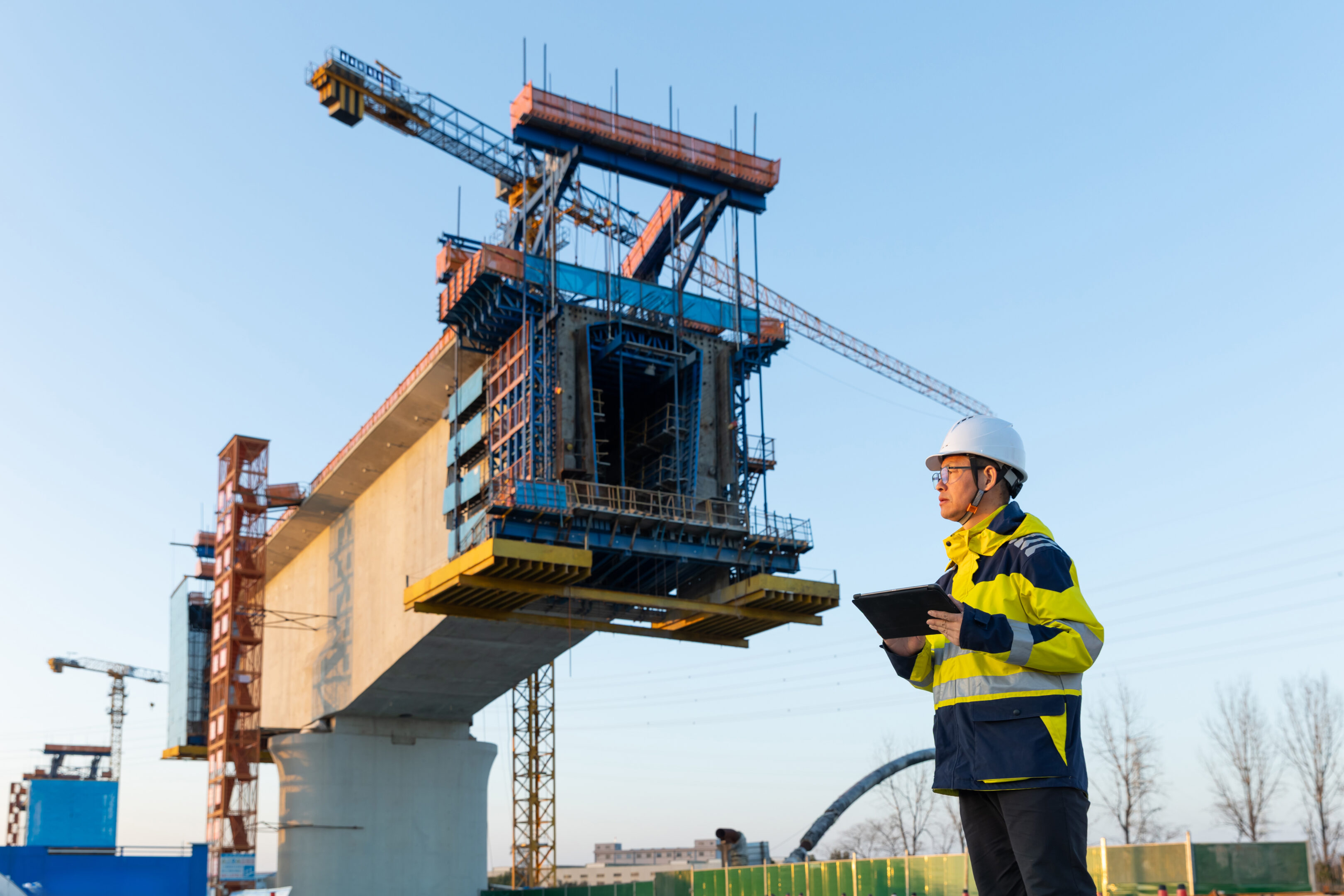 Asian male manager working on digital tablet in construction site