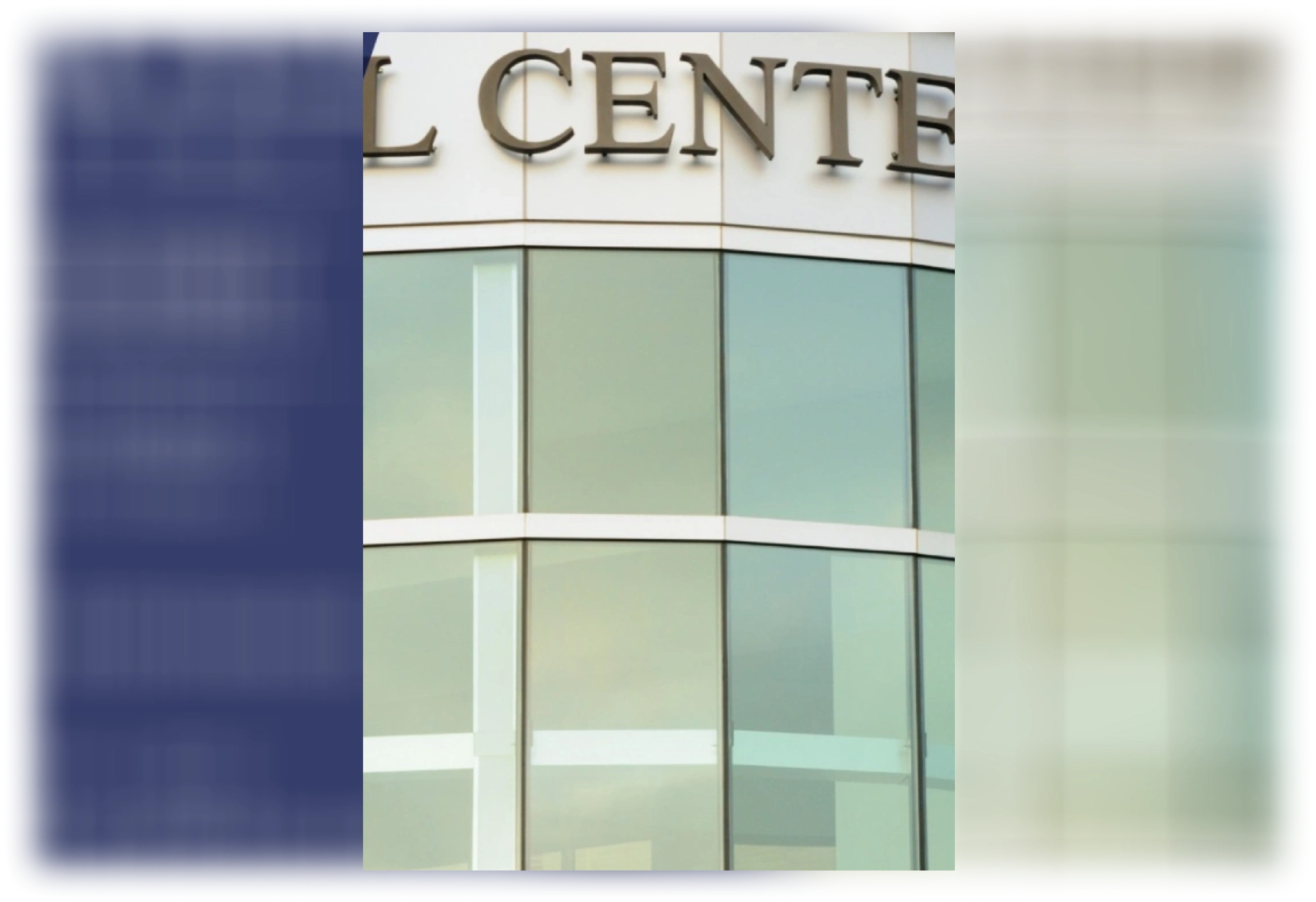 Modern curved glass facade with partial signage